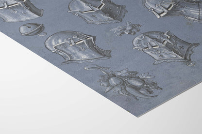 A close-up of a gray patterned sheet featuring embossed or printed medieval-style armor helmets and a floral motif, shown against a white background.