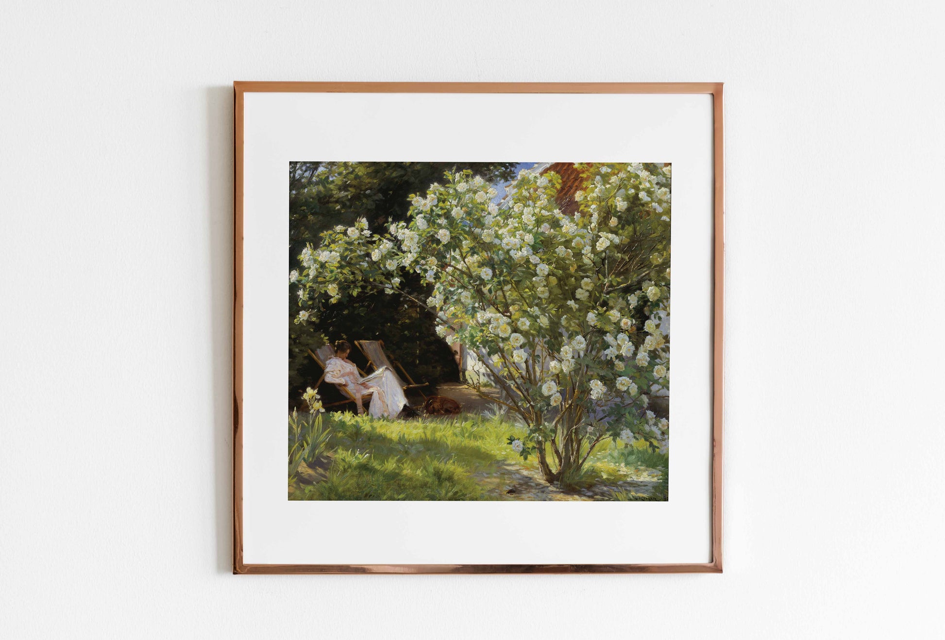 Framed artwork of a garden scene with people sitting under a tree.
