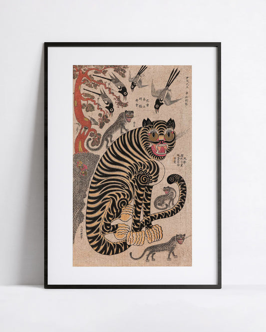 A framed art print featuring a traditional Korean-style illustration of a black and tan tiger with smaller tigrs and magpies  around it, displayed against a clean white wall.