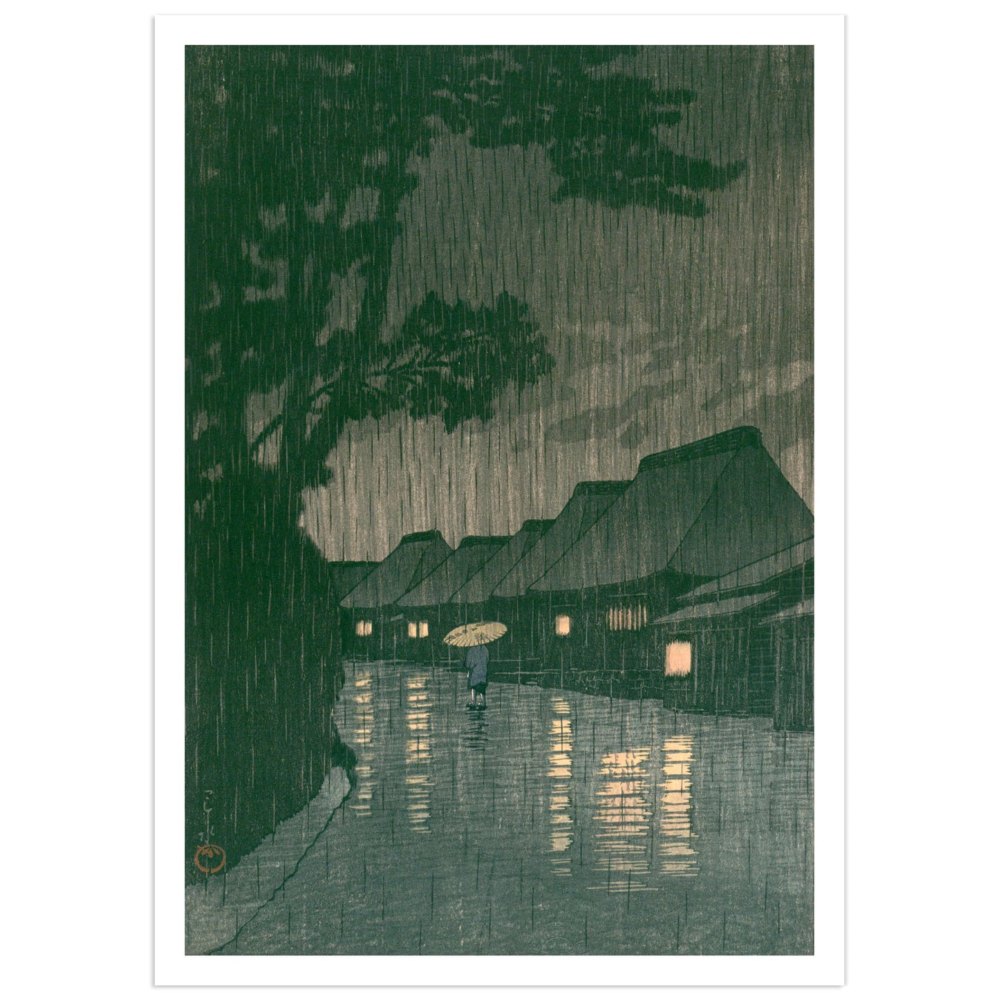 Sōshū Maekawa no Ame (Rain at Maekawa, Sagami Province) — Kawase Hasui. Japanese woodblock print depicting a solitary figure with a paper umbrella walking a flooded village road at night in heavy rain, lantern light reflecting on wet ground, deep green pine trees looming overhead. Shin-hanga art print.