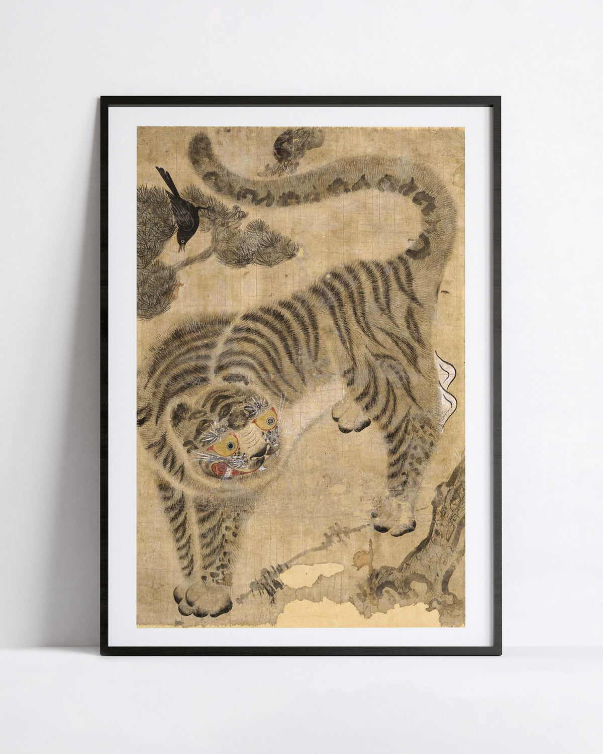 A framed art print featuring a traditional korean-style tiger illustration on an aged beige background, displayed against a clean white wall.