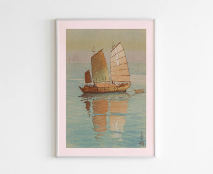 A framed 'Sailing Boats' Japanese print by Hiroshi Yoshida hanging on a wall, enhancing a minimalist home decor.