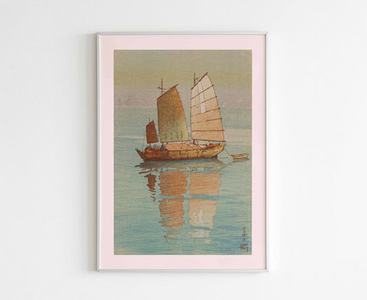 A framed 'Sailing Boats' Japanese print by Hiroshi Yoshida hanging on a wall, enhancing a minimalist home decor.