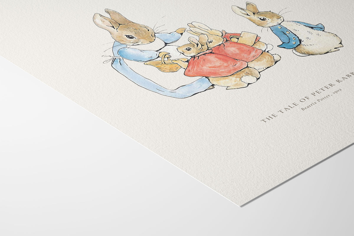A close-up of a textured white art print featuring a watercolor illustration of Peter Rabbit and his children, with the title 'THE TALE OF PETER RABBIT' printed in small serif text.