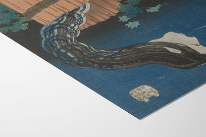 A close-up of a Japanese-style art print or poster showing a blue water scene with a dark wave-like form, tan wood, green leaves, and a small white seal, photographed against a white background.